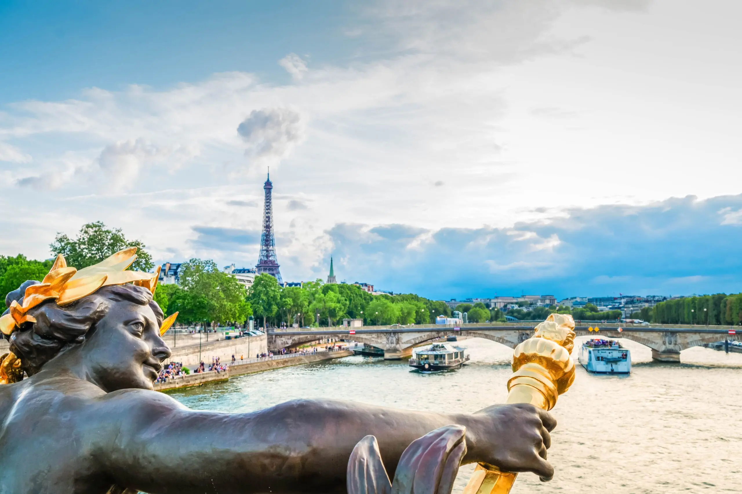 Statue overlooking the Seine and Eiffel Tower in Paris, symbolizing the dream of a French sabbatical or retirement with a visitor long-stay visa