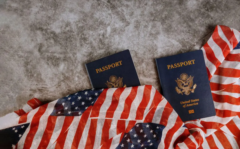 Two American passports resting on a US flag, illustrating French-US dual citizenship