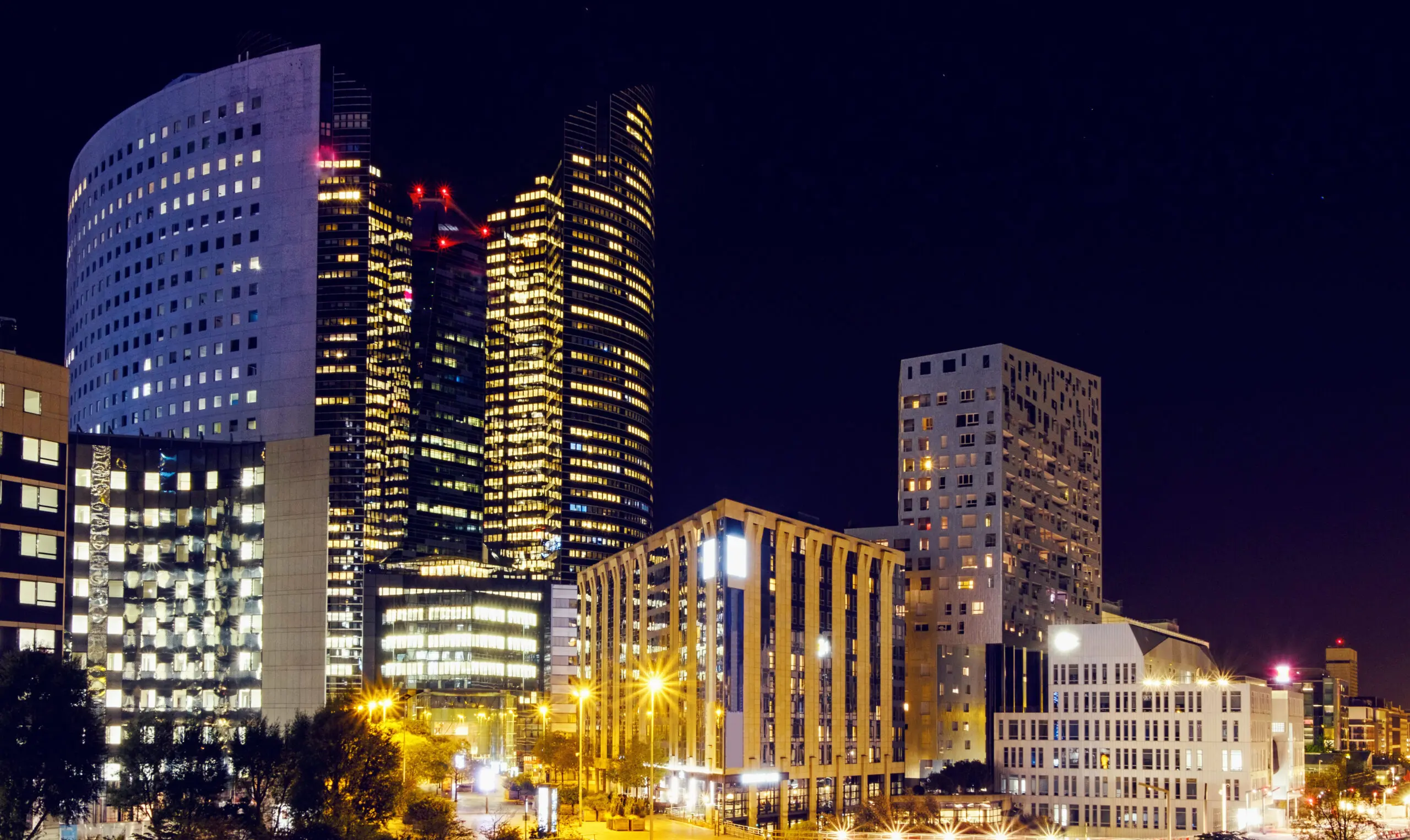 La Défense business district in Paris lit up at night, illustrating types of companies in France for foreign entrepreneurs