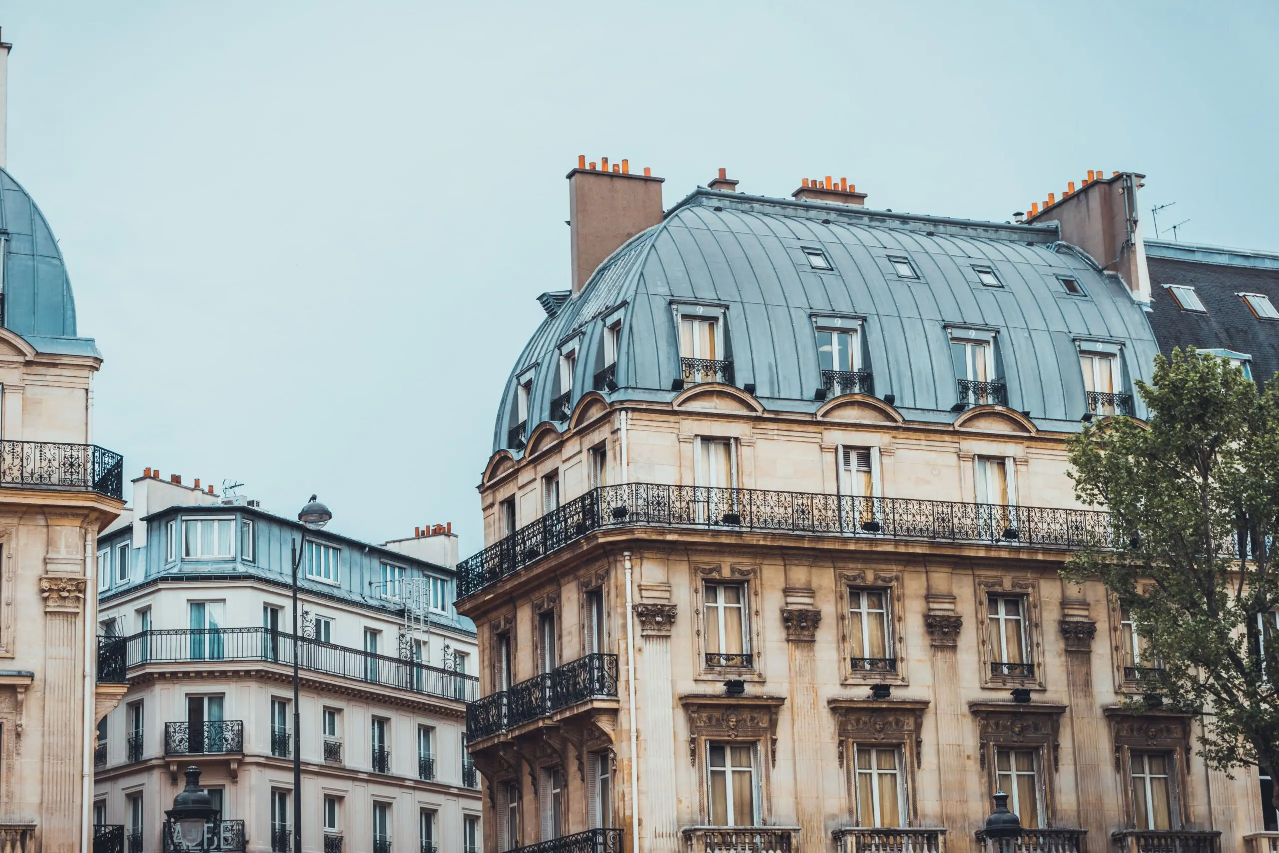 Haussmann-style apartment buildings with wrought-iron balconies, representing renting an apartment in France as a foreigner